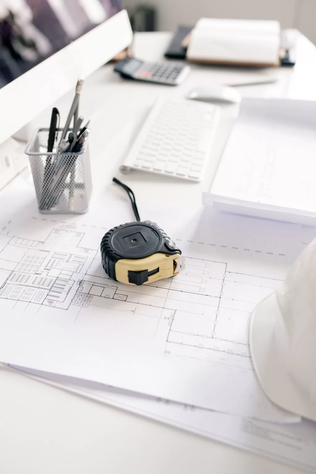 measuring tape pencils and blueprints